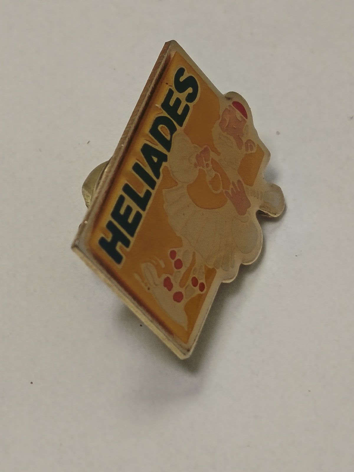 Pin's rétro ancien Héliades ? badge publicitaire vintage collection années 80 90