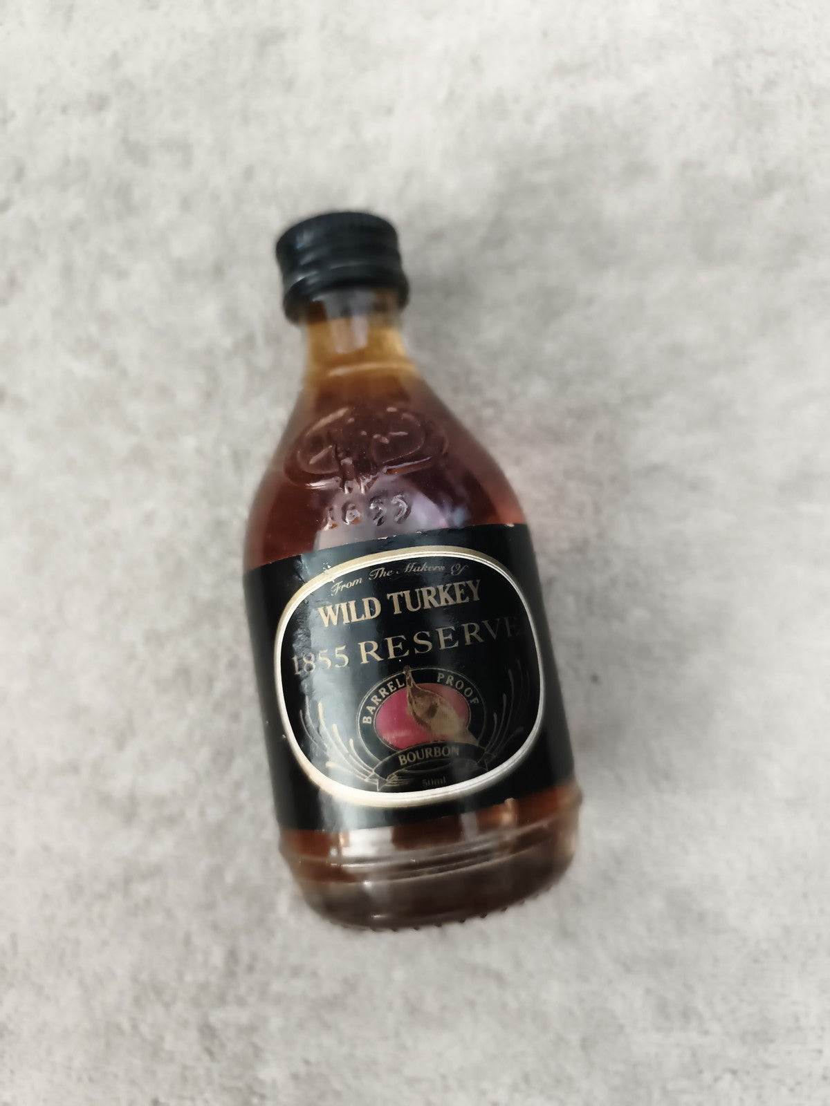 Mini bouteille Wild Turkey 1855 Reserve bourbon partiellement remplie