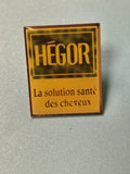 Vintage pin's Hégor publicité santé cheveux carré jaune ancien (Ref 19)